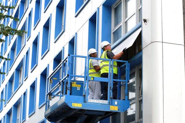 Cladding being removed from Horatia House and Leamington House on Friday evening.Picture: Sarah Standing