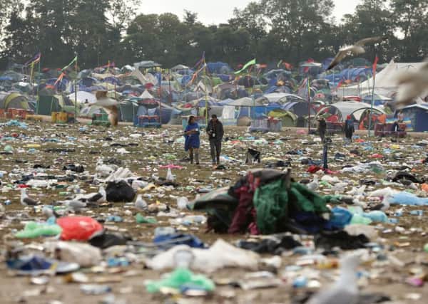 The litter strewn around the Pyramid Stage area as the clean up operation begins on site, at the Glastonbury Festival, at Worthy Farm in Somerset. PRESS ASSOCIATION Photo. Picture date: Monday June 30, 2014. Photo credit should read: Yui Mok/PA Wire YPN-140630-121400038