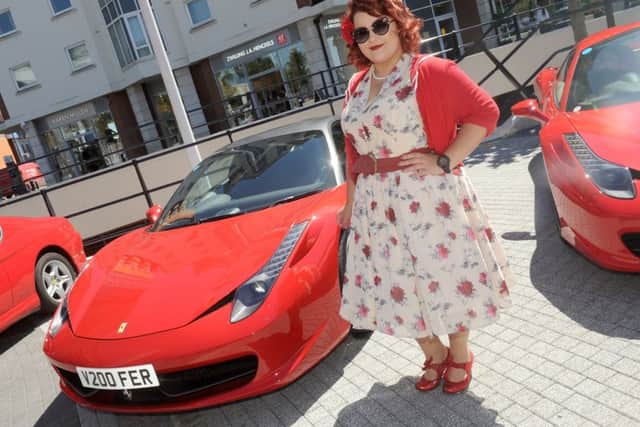 5/7/2017 (HO)
A display of Ferrari's were on display at Gunwharf Quays in Portsmouth on Wednesday afternoon.
Pictured is: Amelia Mugridge (22) from Portsmouth.
Picture: Sarah Standing (170878-4885) PPP-170507-174751001