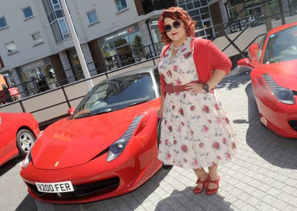 5/7/2017 (HO)
A display of Ferrari's were on display at Gunwharf Quays in Portsmouth on Wednesday afternoon.
Pictured is: Amelia Mugridge (22) from Portsmouth.
Picture: Sarah Standing (170878-4885) PPP-170507-174751001