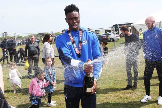 Amine Linganzi celebrates Pompey's League Two title success on Southsea Common Picture: Joe Pepler