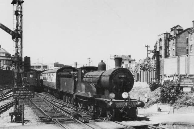 When Britain had a navy there was a great need to move its men from port to port and on a summer day in July 1959 the Portsmouth & Southsea to Plymouth express can be seen approaching Fratton station where it would pass through non-stop.
A loud warning bell located on the fence to the front of the locomotive would sound to warn anyone wanting to cross the track by footboards at the end of the station and in between the platforms.
Although the sign states passengers must use the bridge, women with prams would be escorted by a member of staff  across the line at this point.
A Hampshire  diesel unit has just left the platform on the down side  and the signalman has yet to put the starting signal back to stop.
Above the  blood and custard liveried first carriage can be seen the Guards clothing factory  south of Fratton Bridge.
