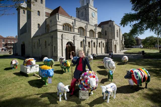 Dominika Gumiela, aged 11, from Oakfield C of E Primary School in Ryde outside Portsmouth Cathedral with the sheep Picture: Peter Langdown