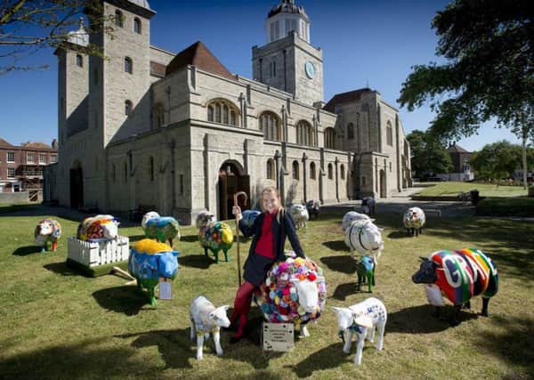 Dominika Gumiela, aged 11, from Oakfield C of E Primary School in Ryde outside Portsmouth Cathedral with the sheep Picture: Peter Langdown