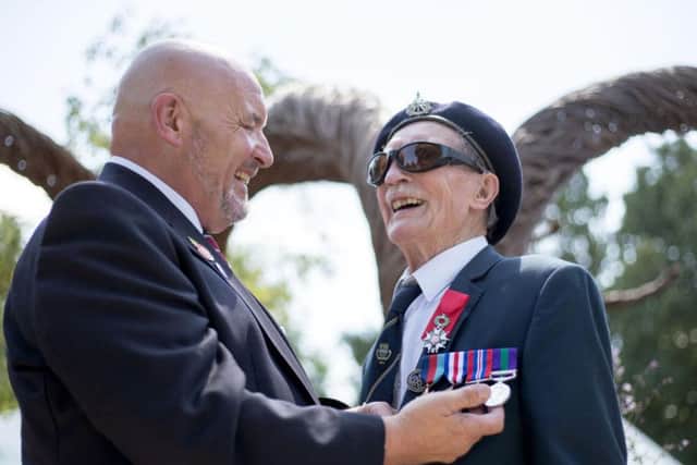 Blind D-Day veteran Alfred Barlow (right), 96, who lost his medals at a motorway service station, with replacements engraved by Graham Short (left) that were presented to him at a ceremony at the Hampton Court Flower Show in south west London.