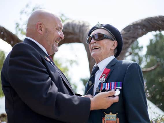 Blind D-Day veteran Alfred Barlow (right), 96, who lost his medals at a motorway service station, with replacements engraved by Graham Short (left) that were presented to him at a ceremony at the Hampton Court Flower Show in south west London.