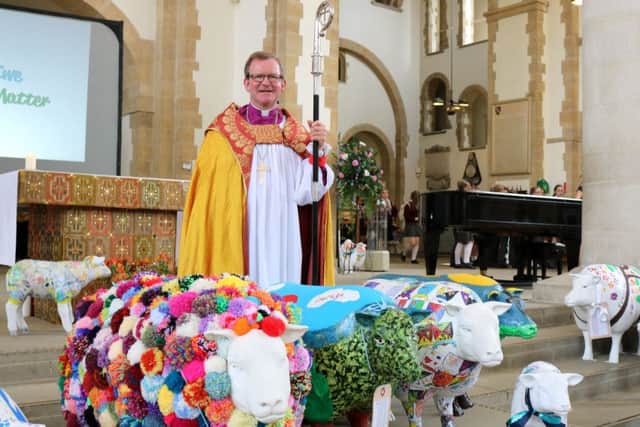 Bishop Christopher Foster with some of the sheep
