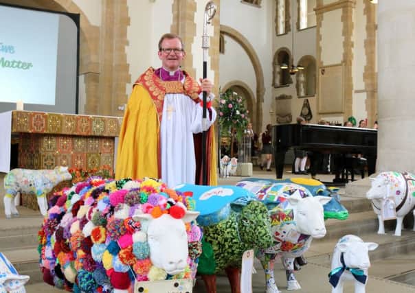 Bishop Christopher Foster with some of the sheep