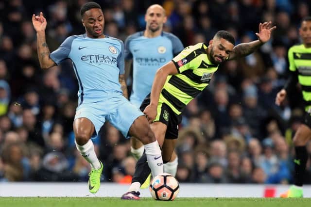 Tareiq Holmes-Dennis battles for possession with Manchester City's Raheem Sterling in the FA Cup last season