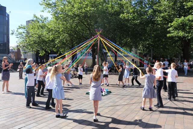 Milton Park Primary School pupils dance around the Maypole