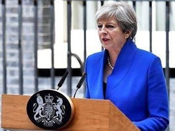 Theresa May the day after the General Election (PA picture) and, below, Rev Sean who believes there are benefits to failing