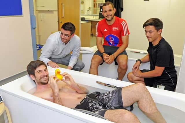 Reporter Tom Cotterill has a friend for company as he tries out his ice bath, with scientific observation by, from left: Dr Joe Costello and technicians Danny White and Harry Mayes      Picture by:  Malcolm Wells (170707-3427)
