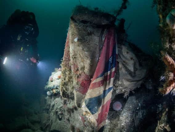 A Royal Navy diver at the wreck of HMS Vanguard