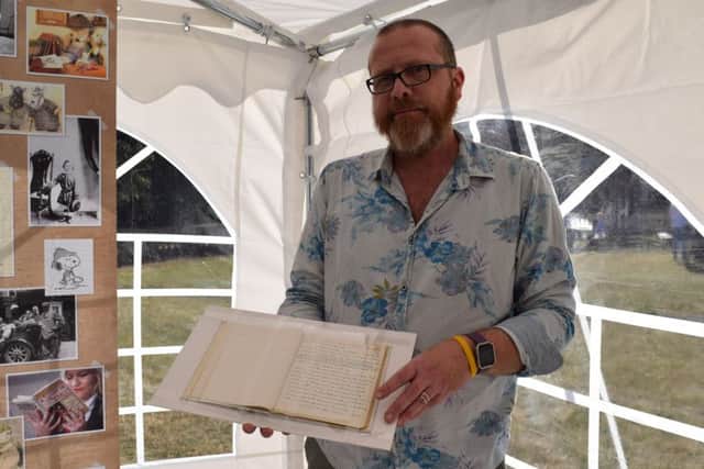 Professor Neil McCaw with the handwritten manuscript