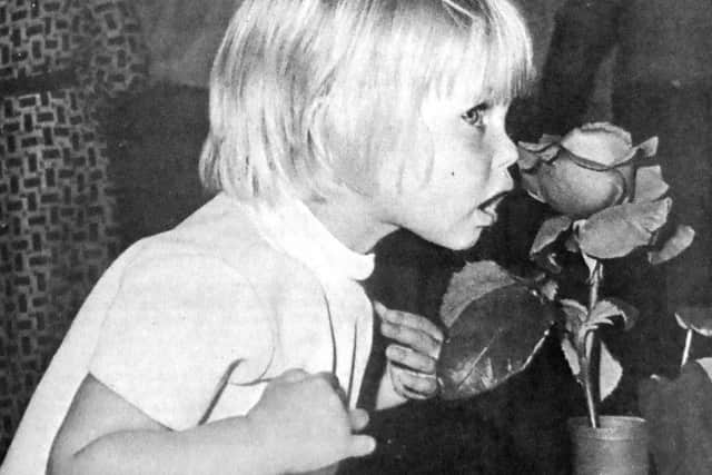 Its 1973 and Amanda Bridgland, as she was then, is caught by a News photographer sniffing her dads rose.