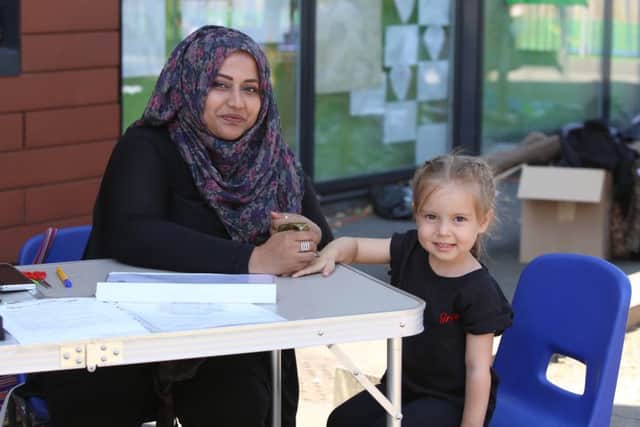 Jasmin 'Jazz-up' Choudhury making Henna Tattoo's on four-year-old Grace Palmer's hand