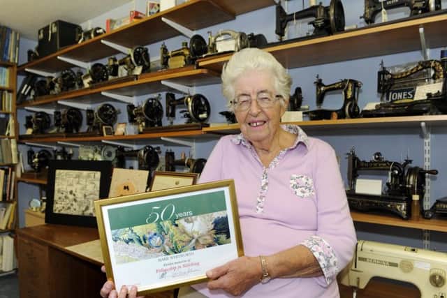 Marie with her award - and her impressive collection of sewing machines. Picture Ian Hargreaves