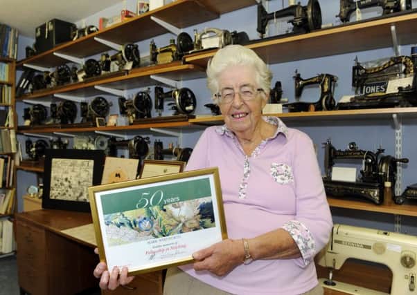 Marie with her award - and her impressive collection of sewing machines. 
Picture Ian Hargreaves