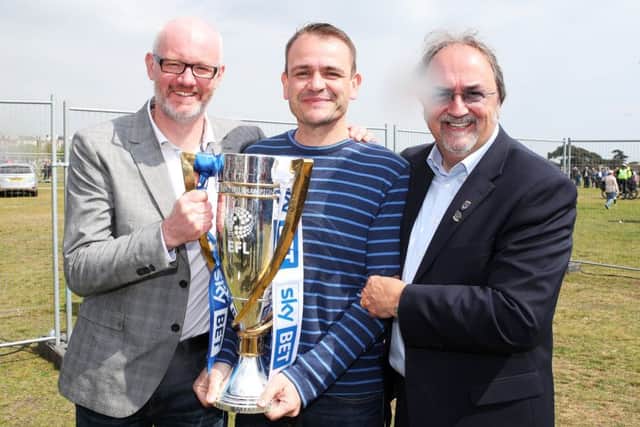 Mark Trapani celebrates the League Two title win on Southsea Common with Ashley Brown and John Kimbell. Picture: Joe Pepler