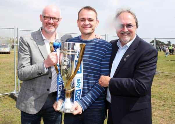 Mark Trapani celebrates the League Two title win on Southsea Common with Ashley Brown and John Kimbell. Picture: Joe Pepler