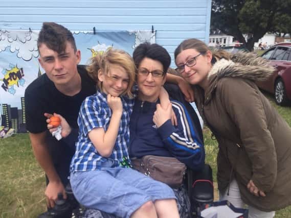 Ben Jackson, centre left, sitting with his mum Lisa, brother Sam and sister Christina
