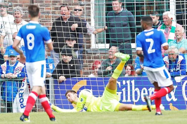 Luke McGee saves from Bognor's Tommy Scutt. Picture: Joe Pepler