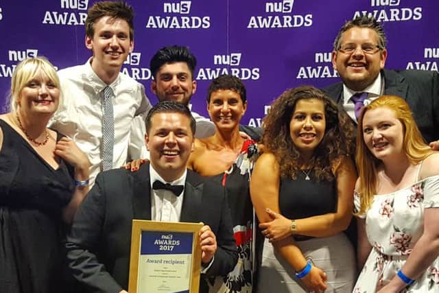 The delighted team with their award