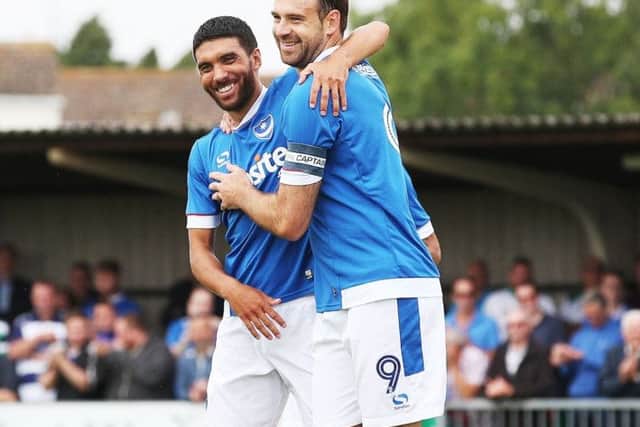 New Pompey skipper Brett Pitman celebrates with Danny Rose after scoring against Rocks