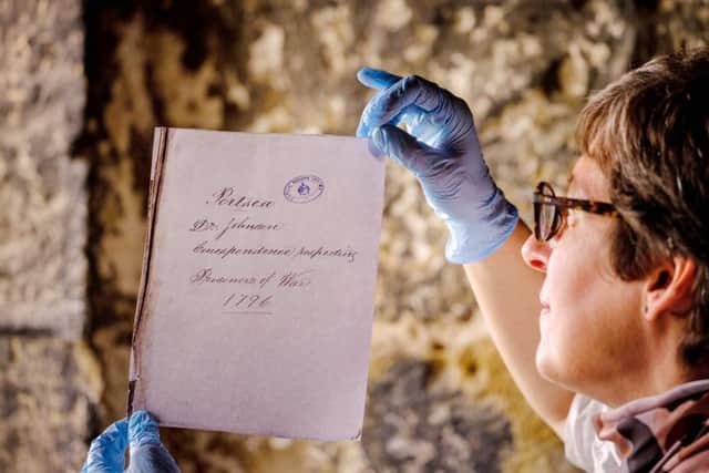 A letter from a Portchester Castle prisoner with English Heritage curator Abigail Coppins Picture: Jim Holden/English Heritage