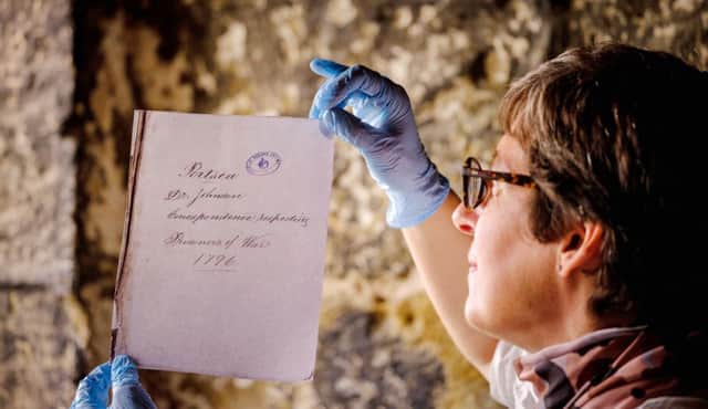 A letter from a Portchester Castle prisoner with English Heritage curator Abigail Coppins Picture: Jim Holden/English Heritage