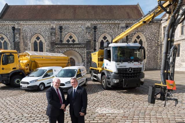 Left, Simon White, Skanska operations director with Cllr Rob Humby, executive member for environment and transport in front of the pothole-busting 'dragon-patcher'
