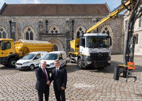 Left, Simon White, Skanska operations director with Cllr Rob Humby, executive member for environment and transport in front of the pothole-busting 'dragon-patcher'