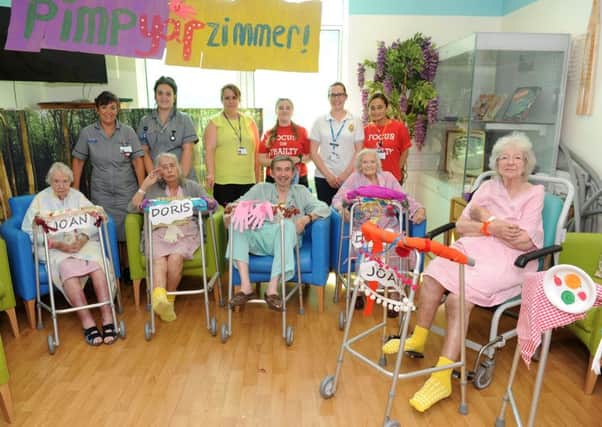 Hospital staff at Queen Alexandra Hospital in Cosham, were helping patients on the Dementia ward decorate their walking frames.

Pictured is: (back l-r) Sarah Smith, Chloe Russell, Kerry Budd, Poppy Young, Sarah Pomfret and Evelyn Donoghue with patients (front l-r) Joan Tuck, Doris Bealing, Ronald Rowntree, Doris Long OBE and Joan Horne. 

Picture: Sarah Standing (170879-4934)