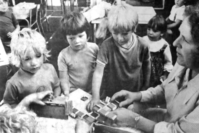 jpns-22-07-17 retro July 2017Nursery - Mrs J Hargreaves, supervisor, plays with some of the children at the nursery school. (0711-1)