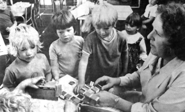 jpns-22-07-17 retro July 2017

Nursery - Mrs J Hargreaves, supervisor, plays with some of the children at the nursery school. (0711-1)