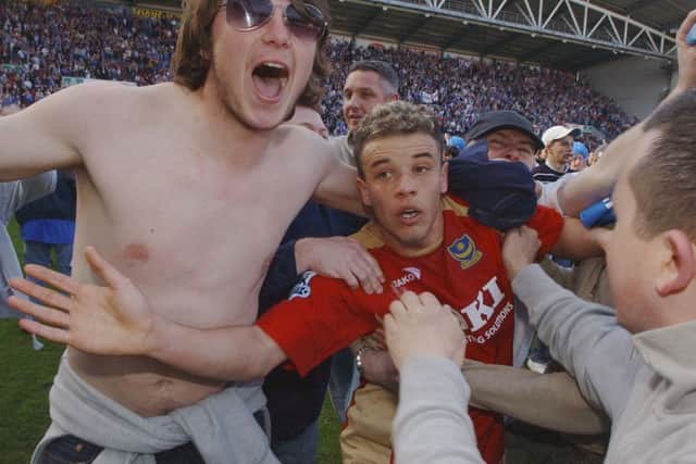 Andres D'Alessandro gets mobbed by Pompey fans after the Great Escape was completed at Wigin