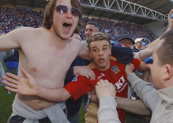 Andres D'Alessandro gets mobbed by Pompey fans after the Great Escape was completed at Wigin