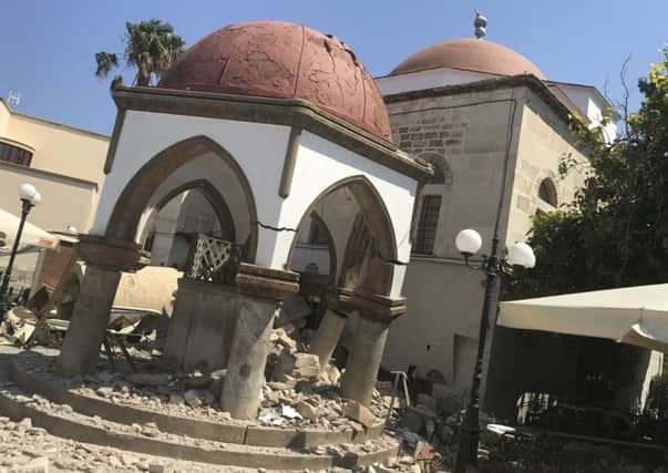 Debris of the collapsed minaret sits around a mosque after an earthquake in Kos on the island of Kos
