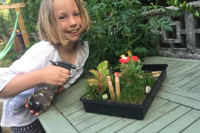 Katy Watson, aged nine, with the gardening creation she made at Family Sunday