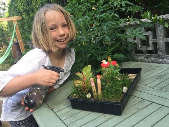 Katy Watson, aged nine, with the gardening creation she made at Family Sunday