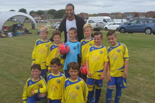 Christian Burgess poses with proud members of the Meon Milton under-10 Burgess team