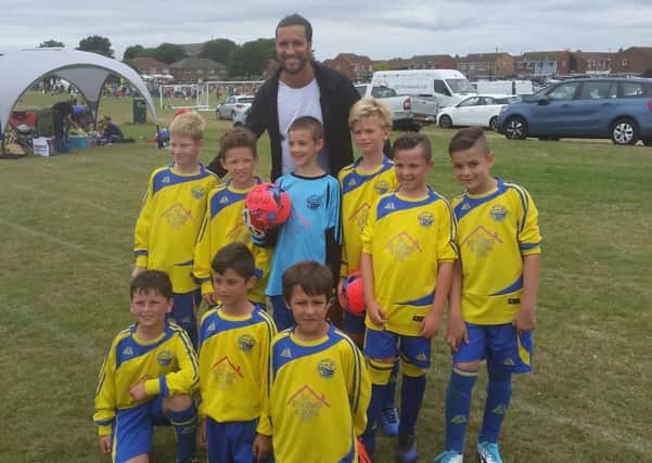 Christian Burgess poses with proud members of the Meon Milton under-10 Burgess team