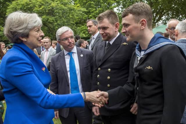 Prime Minister Theresa May meets ET(ME) Robert Morrison and SURG LT CDR Mike Hill