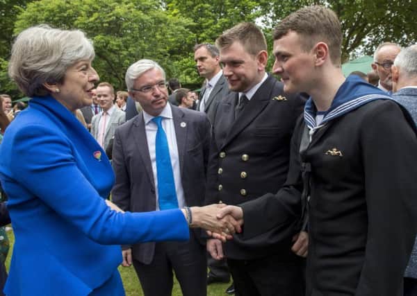 Prime Minister Theresa May meets ET(ME) Robert Morrison and SURG LT CDR Mike Hill