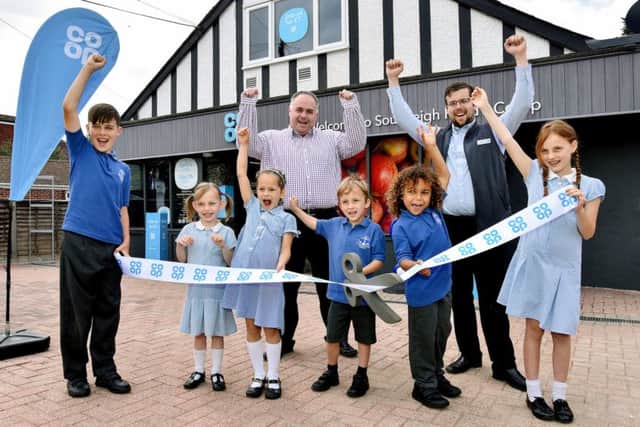 Mark Pearce of Weatherhead Shop Designers, left, with store manager Adam Casey and from left, Frankie, 11, Robyn 5, Eliza 5, Jacob, five, Bily, six and Ruby, eight