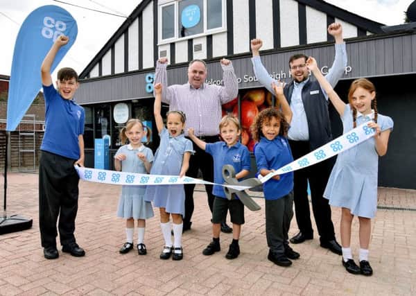 Mark Pearce of Weatherhead Shop Designers, left, with store manager Adam Casey and from left, Frankie, 11, Robyn 5, Eliza 5, Jacob, five, Bily, six and Ruby, eight
