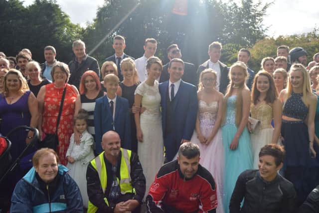 Shannon, centre, poses with friends and family ahead of her prom on Saturday night PPP-170723-105445001