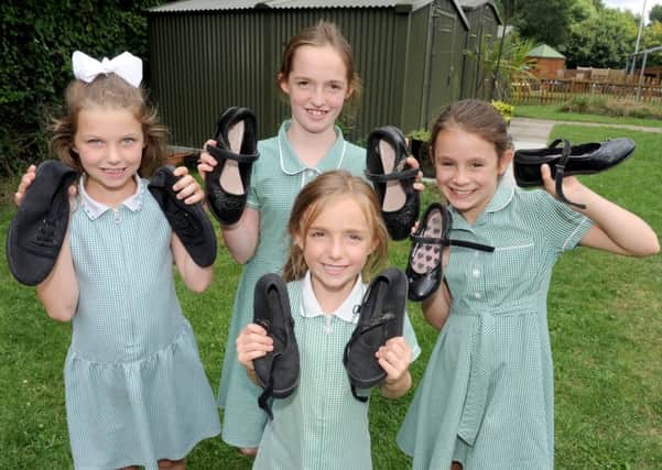 Pupils from Queen's Inclosure Primary School in Waterlooville who have donated their shoes to children in Africa.  Pictured, from left:  Lily I'Bell (8), Scarlett Bugler (10), Lucia Aldred (9) and (front) Lily Bugler (5).  Picture: Sarah Standing (170967-5871)