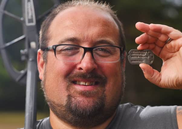 Detectorist Chris Belcher-Banes with the dog tag lost over 70 years ago during World War II that he found buried in a field Picture: Solent News & Photo Agency
UK