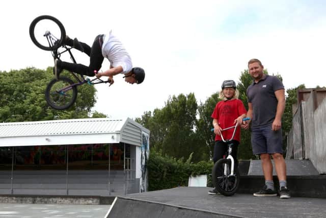 Oakley Way, 17 does a stunt beside his brother, Reef and father, Tim Hunter